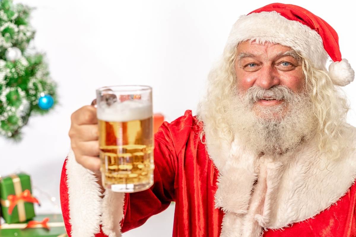 Santa drinks a cold glass of beer