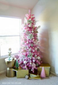 Flocked with pink white Christmas tree with golden presents