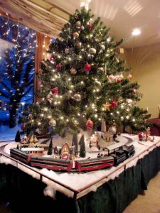 Christmas tree with lights and train track